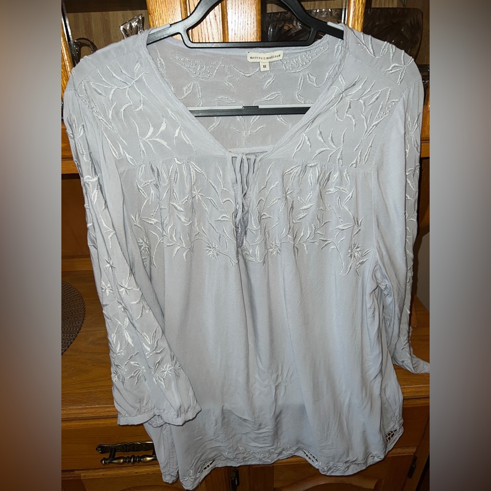 Grey blouse with flowering detail.